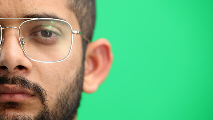 Man's face, on a green background, close-up