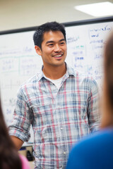 Obraz premium Asian Man Brainstorming Strategies for Startup Success in a Collaborative Environment