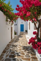 Naklejka premium Narrow alleyway with a blue door and a tree with red flowers. The alleyway is lined with white buildings and has a stone walkway