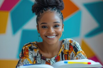 A smiling young Black woman with braided hair sits before open books, radiating joy and academic focus.
