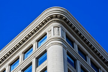 City building corner detail, ornate facade, clear sky, architectural design, real estate