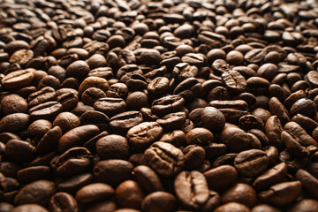 Aromatic roasted arabica robusta coffee beans. Coffee production. Brewing. Close-up textured Background. Detail. Selective focus.