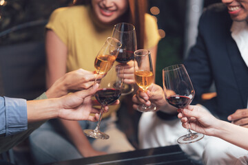 Cheers to Connection: A close-up shot captures the joy and intimacy of friends raising their glasses in a toast, their smiles and gestures conveying a sense of celebration and camaraderie. 