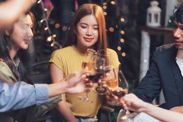 Friends Cheers: A group of close friends raise their glasses in a toast, their smiles radiating warmth and camaraderie, creating a scene of intimacy and joy.