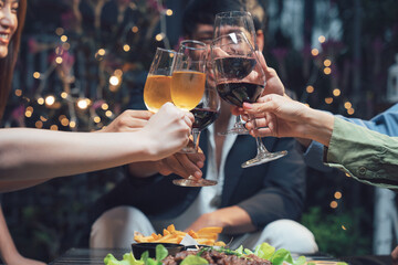 Cheers to Friendship: A close-up shot captures the hands of friends raising their wine glasses in a...