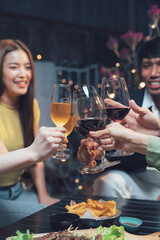 Cheers to Friendship: A group of diverse friends raise their wine glasses in a celebratory toast, enjoying a delightful evening together filled with laughter and good company.