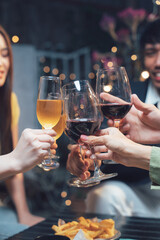 Cheers to Connection: A group of friends raise their wine glasses in a toast, capturing the essence of togetherness and celebration. The warm glow of the setting sun illuminates the scene.