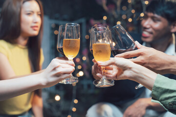 Cheers to Connection:  A close-up of four hands raising glasses in a toast, capturing the warmth and joy of celebration and friendship.  