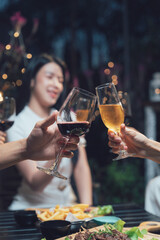 Cheers to Friendship: Close-up shot of friends raising their glasses in a toast, their faces slightly blurred, focusing on the moment of connection and celebration during a dinner gathering.