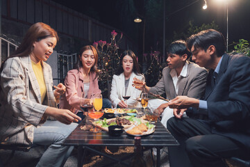 After-Work Celebration: A group of stylish friends share laughter and conversation over a shared meal and drinks on a warm summer evening, showcasing the joy of social connection and camaraderie.