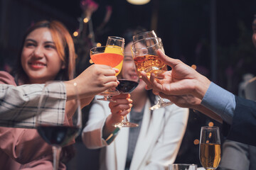 Cheers to Friendship: A group of friends raise their glasses in a celebratory toast, their smiles and laughter conveying genuine connection and joy.