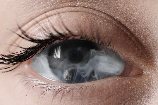 Fototapeta Hypnosis. Hypnotic smoke in woman's eye, closeup