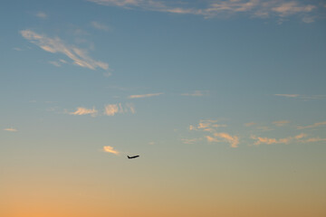 Plane flies at sunset, romantic dusk and aerial beauty, scenic outdoor journey and nature's...