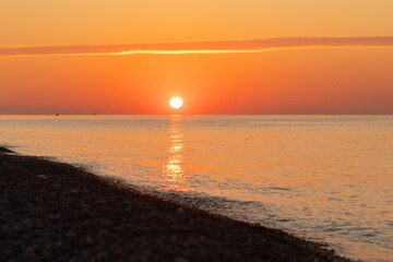 Silhouette of a ship in the sea at sunset opposite the sun, marine lifestyle, nautical expedition, open water travel