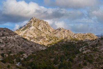 Trevenque mountain peak illuminated by sunlight in Granada, Spain, with dramatic sky