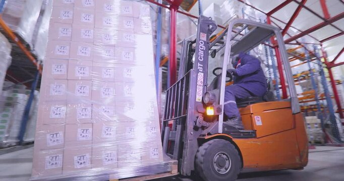 Refrigerated Warehouse. Frozen storage warehouse. Refrigerated and Frozen Food Storage, inside. A forklift operates in a large multi-level warehouse. Warehouse Order Picking
