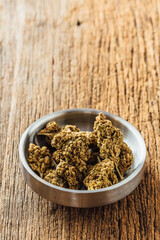 Dried cannabis on wooden background