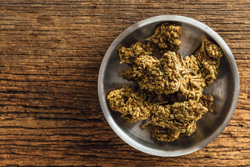 Dried cannabis on wooden background