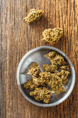 Dried cannabis on wooden background