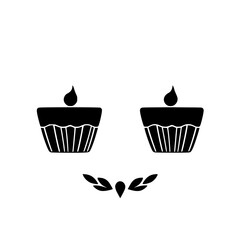 Two black cupcakes with a leaf decoration on white background.