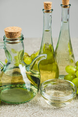 White wine vinegar in a vinegar bowl among grapes