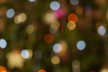blurred multicolored circles of light on a dark background, abstract play of light, beautiful light spots