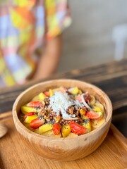 Smoothie bowl with bananas, berries, granola and other ingredients