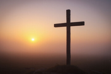 weathered wooden cross in misty rural landscape at dawn