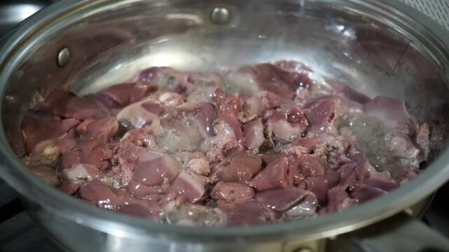 Chicken liver preparation in saucepan, with savory sauce. Healthy food. Commercial kitchen