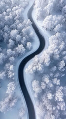 A breathtaking aerial view of a snowy countryside with forest and road