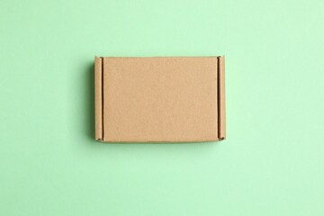 Cardboard box on color background