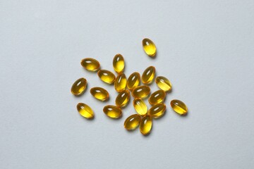 Capsule of omega 3, 6, 9 fish oil, vitamin, food supplement on gray background