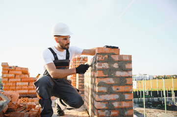 Construction worker in uniform and safety equipment have job on building