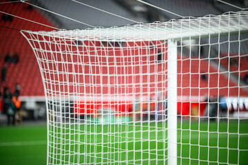 Close-up of a football soccer net on a stadium background.
