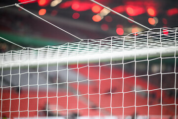 Close-up of a football soccer net on a stadium background.