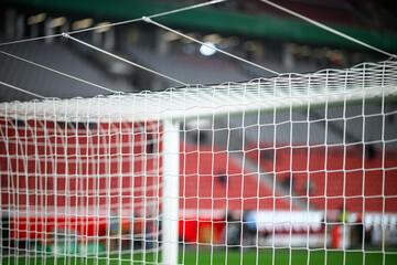 Close-up of a football soccer net on a stadium background.