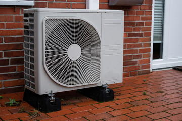 An electrical air conditional system heat pump outside of the building 