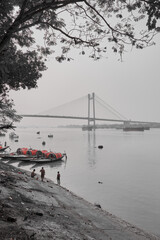 Colorful country boats along the river shore near the Vidyasagar river bridge at Calcutta, India