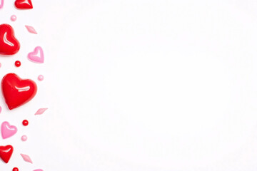 Clean white bg scattered red and pink heart shaped objects