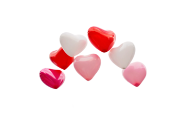 A playful arrangement of colorful, glossy heart shapes in shades of red, pink, and white, exuding charm and vibrance, isolated on a transparent background