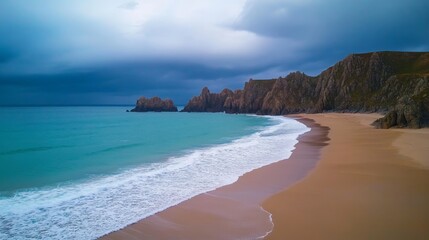 Obraz premium Serene coastal landscape with dramatic cliff and tranquil waves under a moody sky at dusk