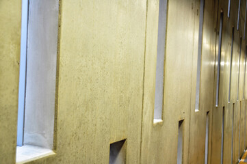 Concrete wall with long tall windows inside the modern building
