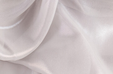 The texture of silk, chiffon transparent fabric is silver colored. Gentle airy waves of fabric....