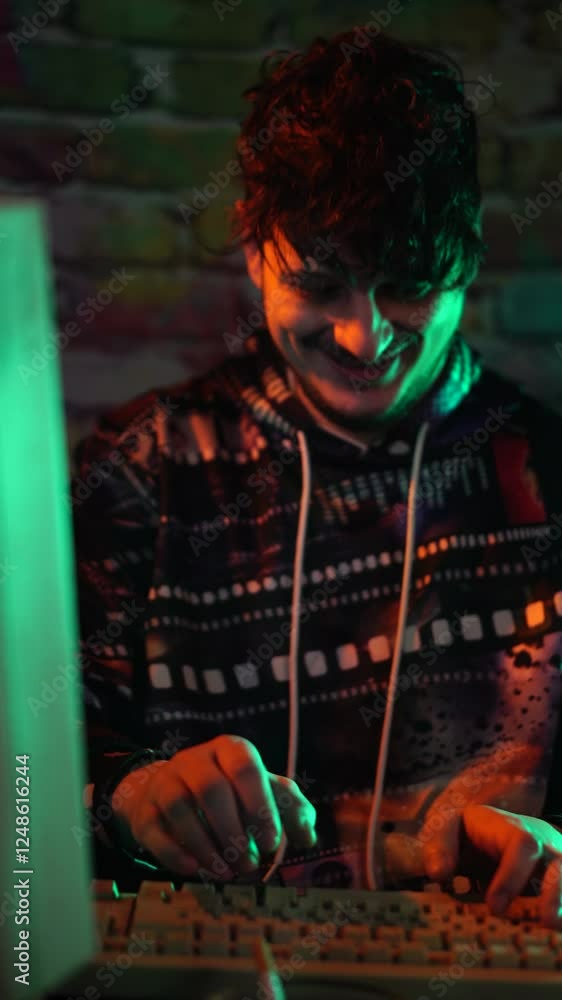 Poster vertical view of young excited man in front of vintage pc computer celebrating success in programmin