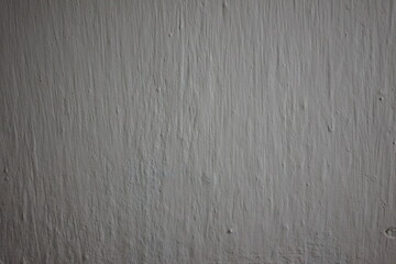 Textured gray wall creating a minimalist backdrop for art or design