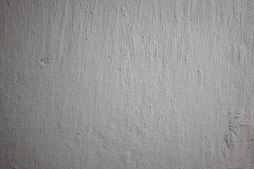 Light gray textured wall showing unique patterns from wear and paint