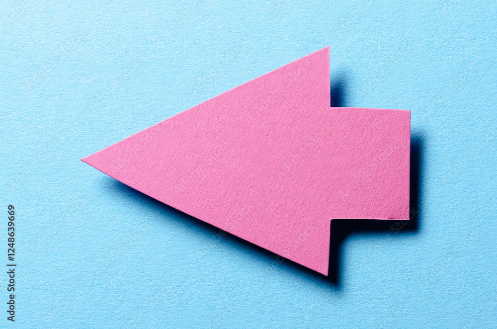 Poster pink cut out blank paper cardboard arrow direction sign with copy space for text on blue background,