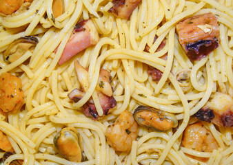 Spaghetti with mixed of cooked seafood (mussels, squid tentacles, prawns). Seafood concept