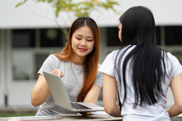 Diverse university students engaging in a study session with a laptop.