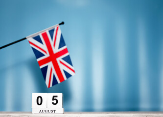 Fototapeta premium Calendar August With British Flag With Number 5. Calendar cubes with numbers. Space copy.